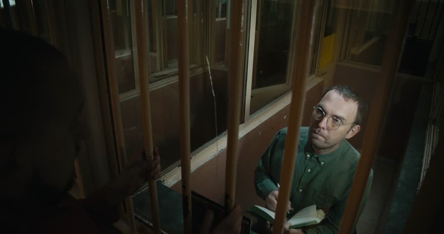 Lawer trying to convince his client. Prisoner doesn