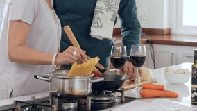 Happy couple cooking, taste food and making meal, lunch or dinner in kitchen at home. Smile mature woman giving man a taste of homemade sauce, spaghetti or pasta to enjoy eating together - Powered by Shutterstock - Get 15% off with code: PIKWIZARD15