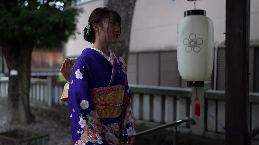 4k60fps Video of a young woman in a blue kimono walking through the old streets of Higashi Chaya-gai, Kanazawa, Ishikawa, Japan 4k60fps