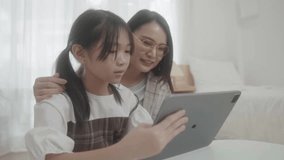 Mother help girl child with home task preparation. Online education concept. Young mom do homework learn distant use computer with daughter. 