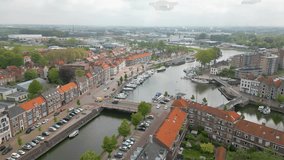 This aerial drone video shows a canal with on both sides typical dutch canal houses in the city of Middelburg, Zeeland, the Netherlands.