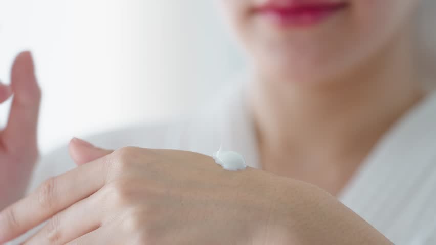 Close up of woman applying moisturizing cream on hand for protection skin. Beauty and body care concept Royalty-Free Stock Footage #1103766461