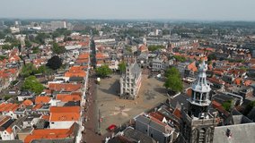 This aerial drone video shows the city square and townhall in the famous old city of Gouda, Zuid-Holland, the Netherlands. This beautiful square is surrounded by typical dutch houses.