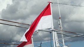 Indonesian flag flutters on a mast on a fishing boat