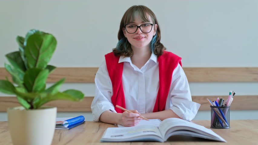 Teenage female student having video conference, talking looking at webcam