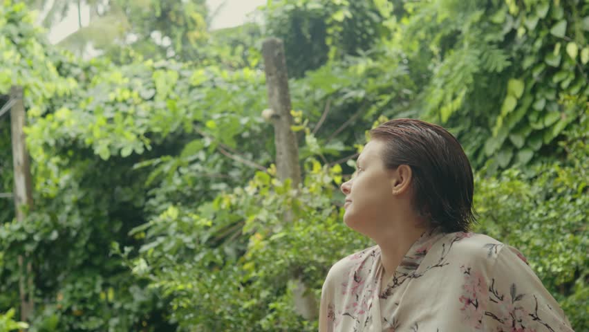 Young woman looking around in tropics.