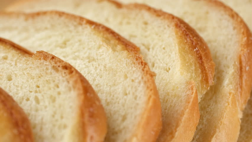 Sliced wheat Bread, slider shot. Texture of baked bread close-up