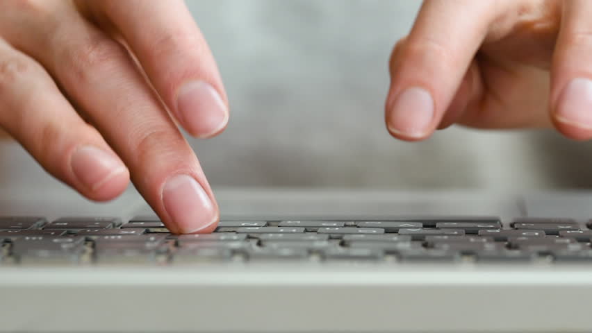 female hands typing on the keyboard close-up