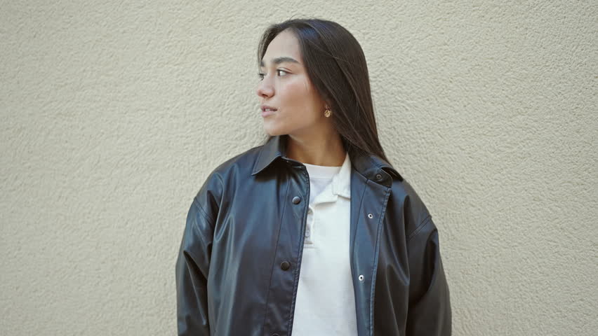 Young beautiful hispanic woman standing with crossed arms over isolated white background
