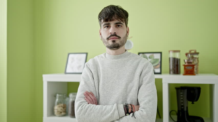 Young hispanic man smiling confident at dinning room