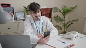 Young hispanic man doctor doing online appointment at clinic