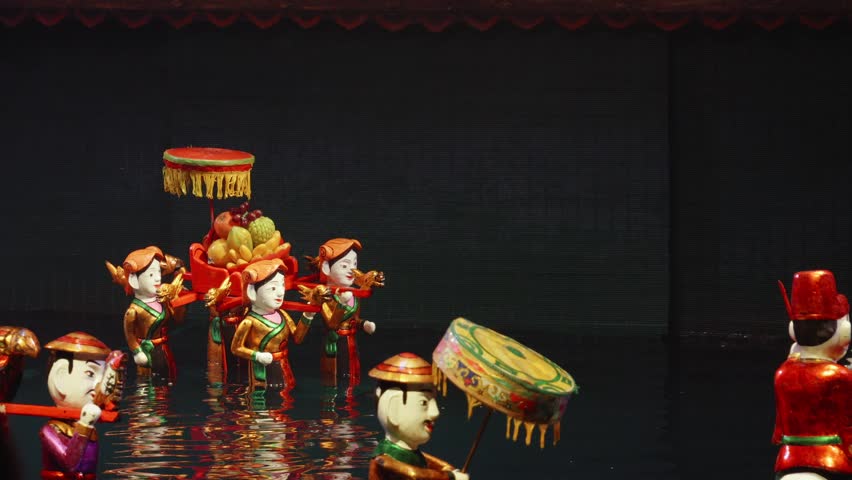 Human Water Puppets Depicting Traditional Vietnamese Folk Tales And Legends Performed In Thang Long Water Puppet Theatre in Hanoi. - close up