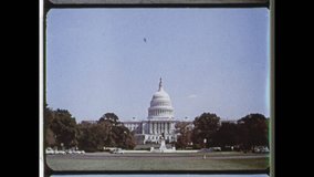 1960 Washington, DC. Establishing Shot of the US Capitol Building. Long shot of Capitol Building, zoom in to reveal The Statue of Freedom. 4K Overscan of vintage archival 16mm newsreel film