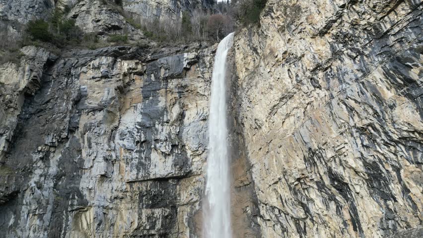 Water cascade that drops sheer from the rocks. Switzerland. Static view