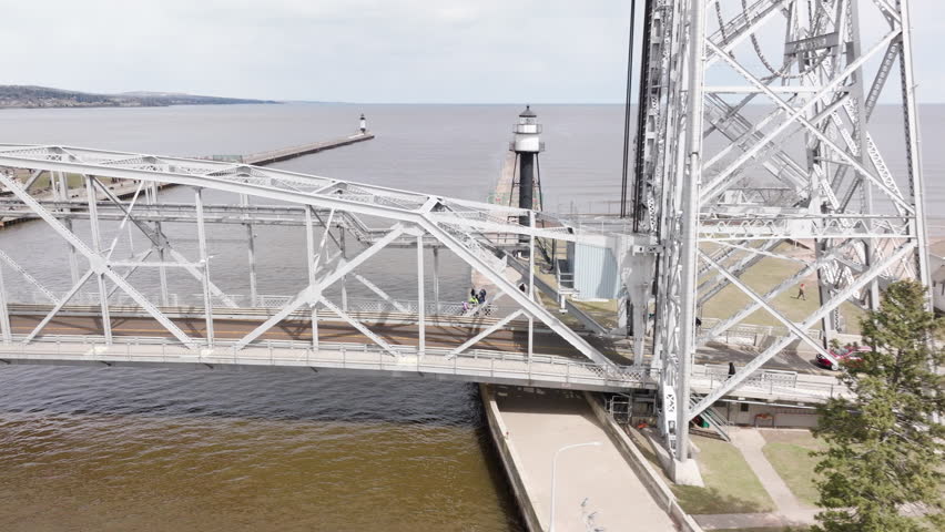 Vehicles crossing aerial lift bridge historic landmark over shipping canal in port city of Duluth, Minnesota