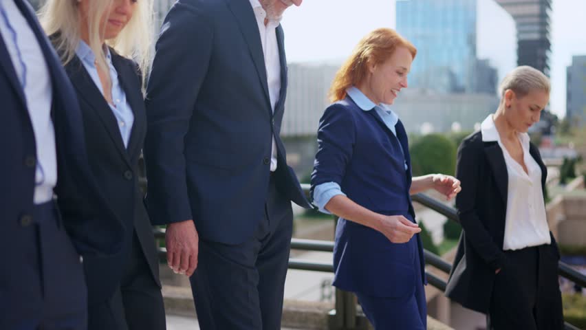 Businesswomen talking while walking down stair with colleagues outdoors Royalty-Free Stock Footage #1103791449