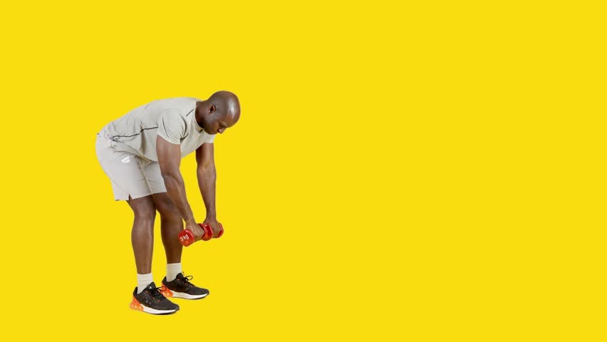 Strong african man doing dumbbell rowing exercises