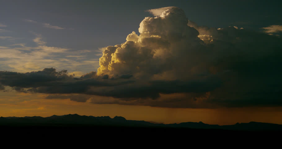 Dreamy desert thunderstorm at magic hour with hypnotic cloud movement. Undercranked at 4 fps.