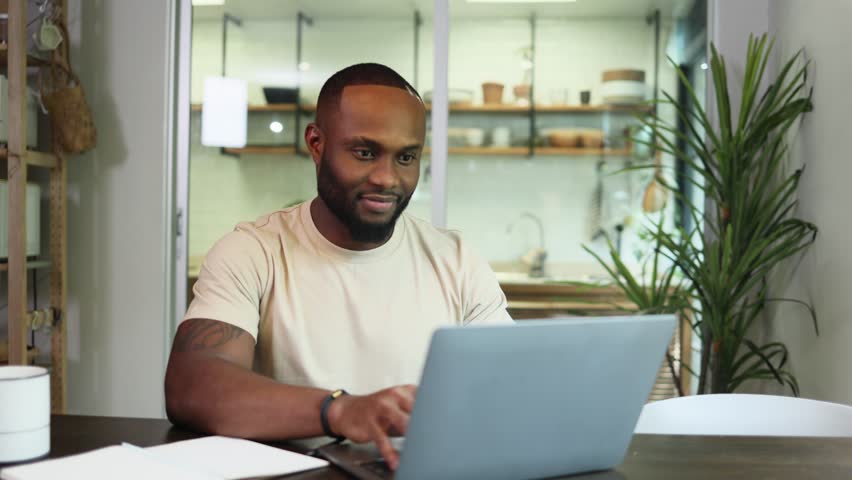 Young business black african american man working from home on table with notebook computer laptop