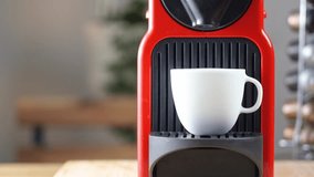 4k video, Automatic coffee machine with black coffee capsules or coffee pods pouring espresso drink in ceramic white cup with hot smoke. Breakfast time with Making Fresh Americano drink.