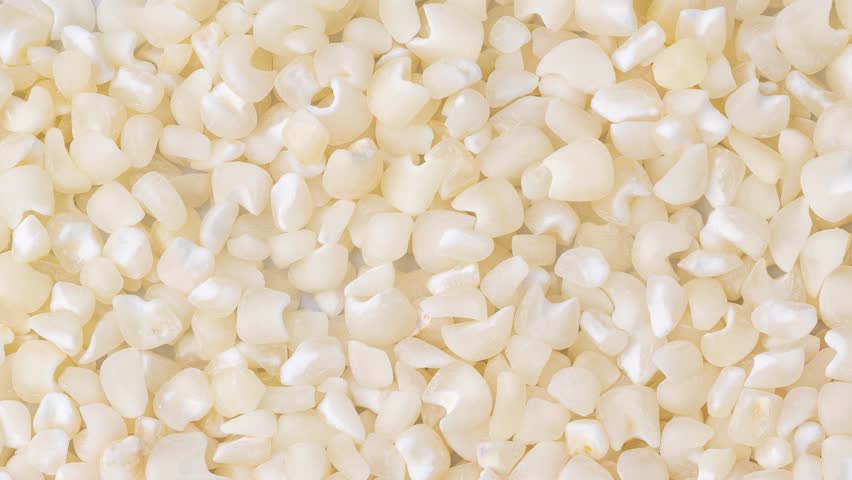 Closeup, top view of dried white corn or canjica. Food backdrop. | Shutterstock HD Video #1103809015