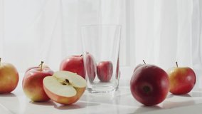 Background video of pouring apple juice into a glass. A slow-motion video of a composition of apples and pouring freshly squeezed juice. High quality 4k footage - Powered by Shutterstock - Get 15% off with code: PIKWIZARD15