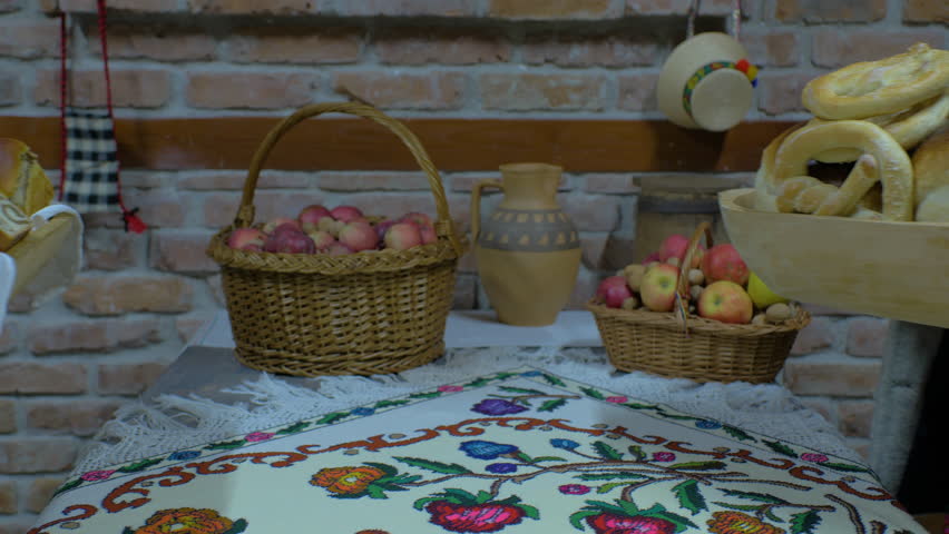 Women In Traditional Clothes Puts Traditional Homemade Food On The Table