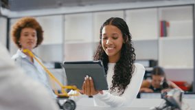 Female teacher with female high school student using digital tablet in STEM class - shot in slow motion - Powered by Shutterstock - Get 15% off with code: PIKWIZARD15