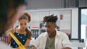 Female teacher with high school students using digital tablet in STEM class - shot in slow motion - Powered by Shutterstock - Get 15% off with code: PIKWIZARD15