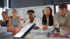 Close up of female teacher with digital tablet teaching high school student STEM class - shot in slow motion - Powered by Shutterstock - Get 15% off with code: PIKWIZARD15