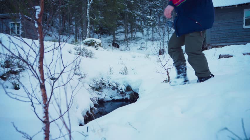 Man With Tumbler Getting Water On A Brook And Drink During Winter. Static Shot