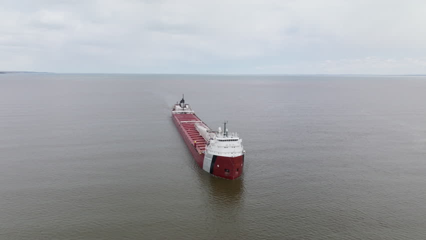 Large natural resources freight shipping vessel transporting minerals along commercial trade route