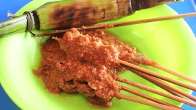 Sate Gogos pokea typical of Kendari, Southeast Sulawesi, Indonesia. Indonesian traditional food. This satay is served with steamed sticky rice.
