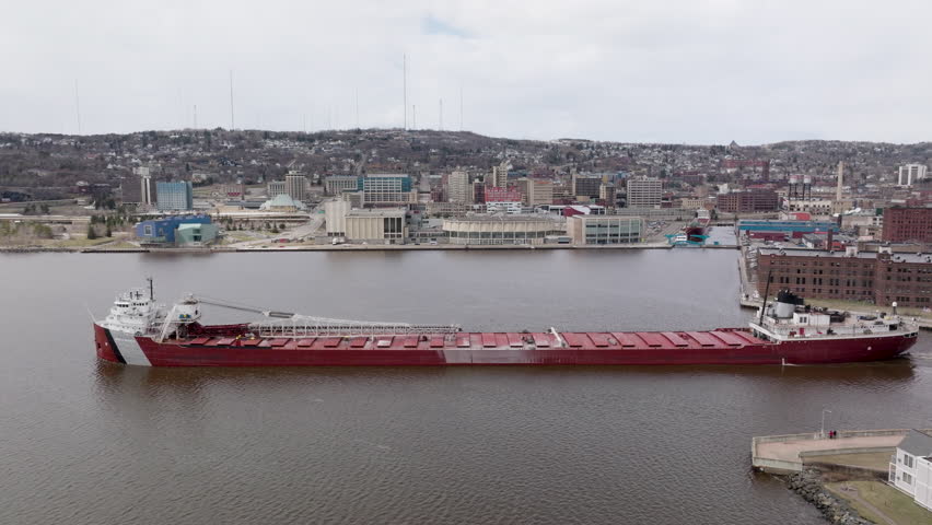 Large natural resources shipping vessel entering Duluth Harbor Basin for exporting iron ore minerals
