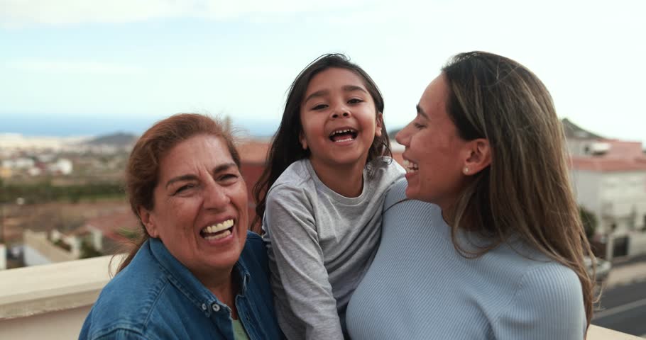 Happy latin multi generational family having fun together while smiling on camera at house rooftop Royalty-Free Stock Footage #1103835727