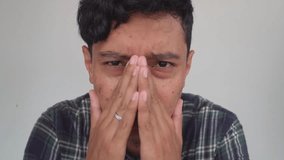 Young man Indonesia stress and disappointed expression with white background. The footage is suitable to use for advertising and expression content media.