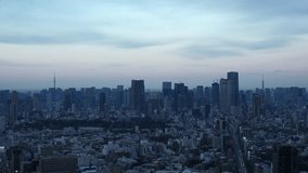 TOKYO, JAPAN : Aerial high angle sunset CITYSCAPE of TOKYO. View of buildings around Roppongi from Shibuya. Time lapse shot, dusk to night. Japanese urban city life and metropolis concept video.