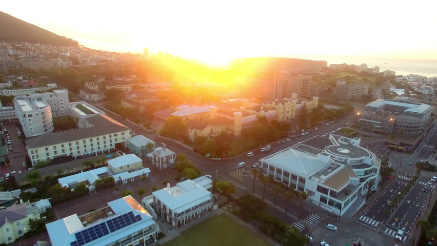 Mountains, stadium and sunset with drone of city of cape town with street, shopping mall or architecture. Travel, nature and luxury with landmark location by ocean for tourism, buildings or landscape