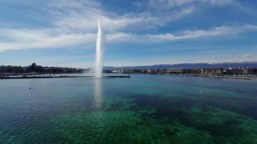  Geneva famous Water Fountain ,Jet d'Eau  in Geneva Lake, Switzerland. sunny day ,aerial drone shot.alps in the background. Royalty-Free Stock Footage #1103846951