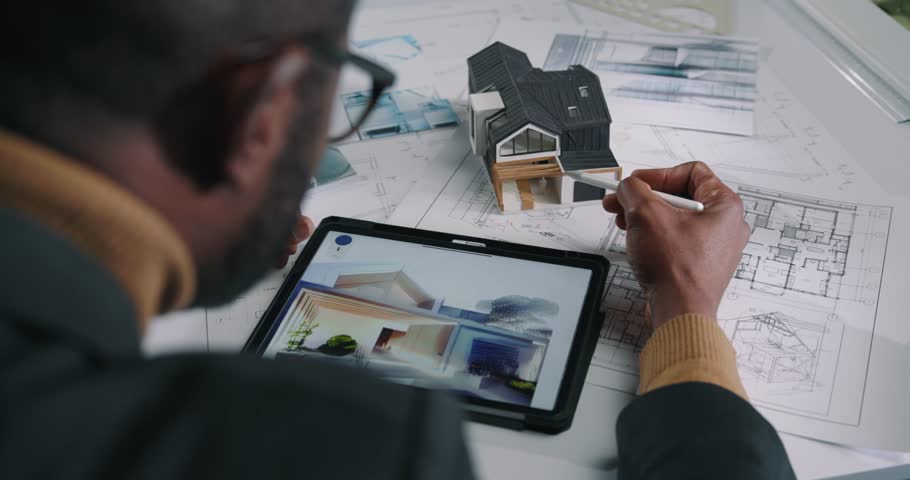 Behind shoulder shot of an African American architect drawing the house layout. Royalty-Free Stock Footage #1103849401