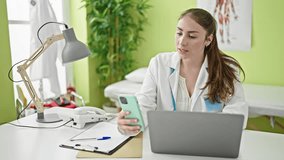 Young beautiful hispanic woman doctor using smartphone having online consultation at clinic