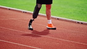 Cinematic close-up of a disabled man with a prosthetic leg on a treadmill. The concept of an active life position of disabled people, their determination and motivation. - Powered by Shutterstock - Get 15% off with code: PIKWIZARD15