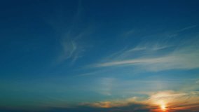 Sunset sky. Red purple orange blue pink sunset sky clouds. Jet contrail as airplane streaks across the sky with golden sunset clouds. Time lapse. - Powered by Shutterstock - Get 15% off with code: PIKWIZARD15