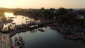 Aerial 4K drone footage of Hoi An city, Vietnam. Ancient town, UNESCO world heritage, at Quang Nam province. One of the most popular touristic destinations with many boats in river