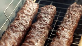 Turkish Cuisine Charcoal Grill Lamb Charred Meat. Culinary Traditional Smoky Barbeque Adana Kebab. Roasted Halal Shish Meat. Cook Roasts Shish Kebab Barbecue On Grill. Arabic Food Grilled On Skewers - Powered by Shutterstock - Get 15% off with code: PIKWIZARD15
