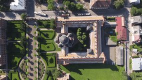 Flight over an ancient building palace castle with multi-colored roof. Chernivtsi National University. Drone video.