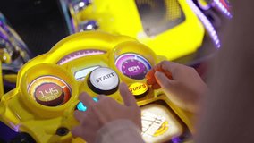 Close up on hand of woman enjoy playing moto bike arcade game in game center, Hobby and leisure lifestyle on weekend or vacation.