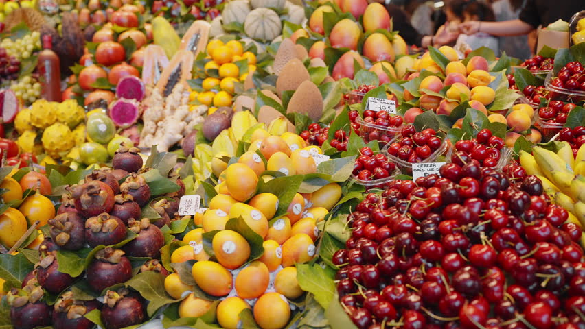 Exotic fruits and vegetables Central Market Barcelona, Spain showcase cherries, mango, papaya, apricots of fresh beautifully arranged. Healthy nutrition, health and vitamins Royalty-Free Stock Footage #1103863023