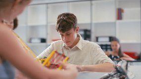 Female teacher with male high school student using digital tablet in STEM class - shot in slow motion - Powered by Shutterstock - Get 15% off with code: PIKWIZARD15