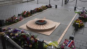 High-angle view of eternal flame above tomb of unknown soldier under the Arc Triomphe on Bastille Day. One of most famous monuments in France. Concept of vacations in France. Shooting in slow motion - Powered by Shutterstock - Get 15% off with code: PIKWIZARD15